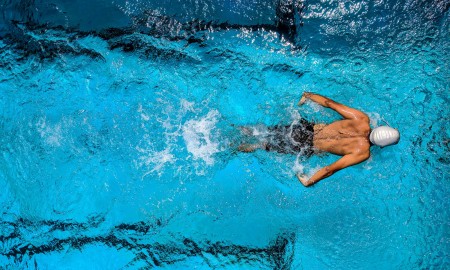 Person Swimming on Body of Water